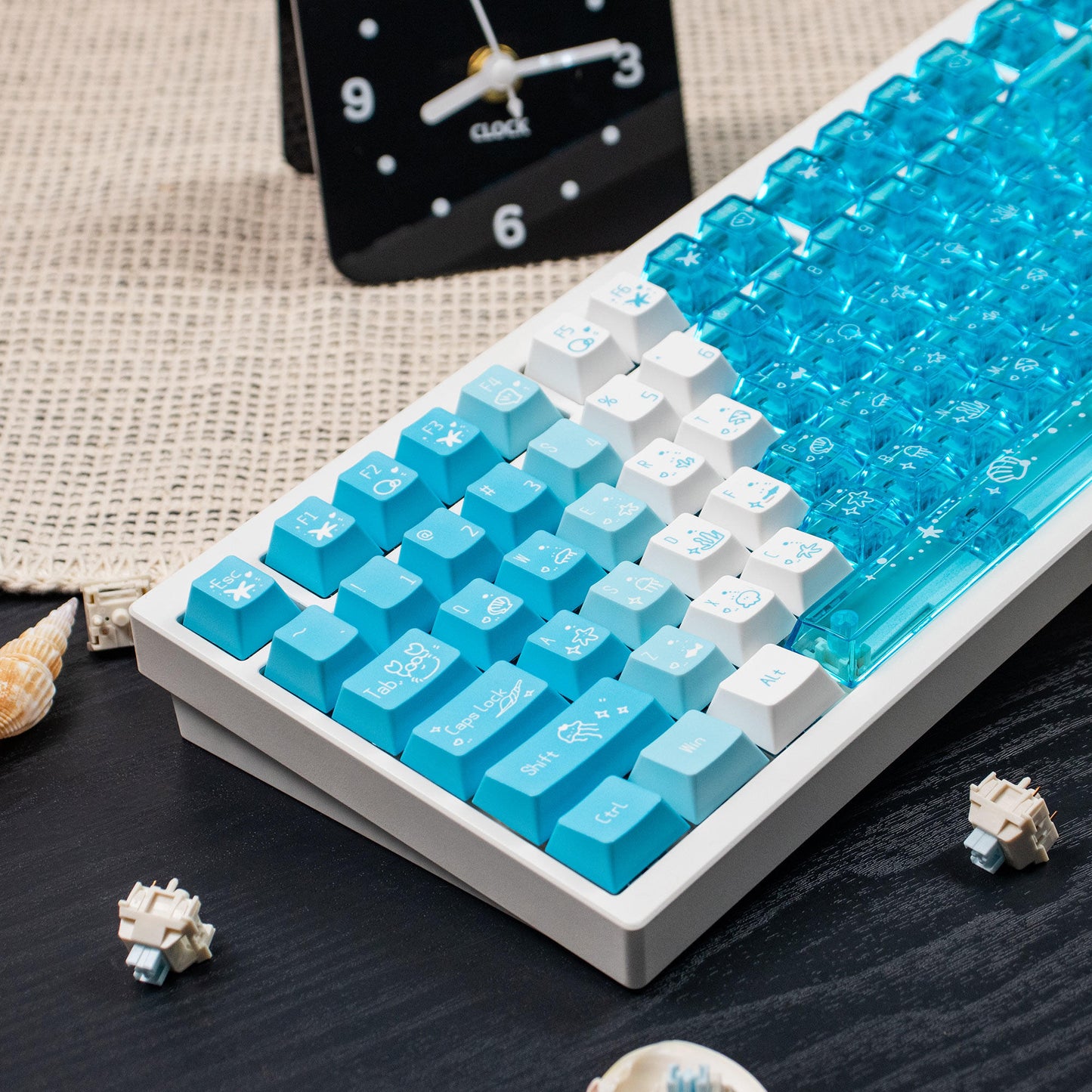 Keyboard with blue and white keys on a wooden surface with a clock in the background