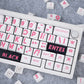 Keyboard with pink lettering on a gray surface