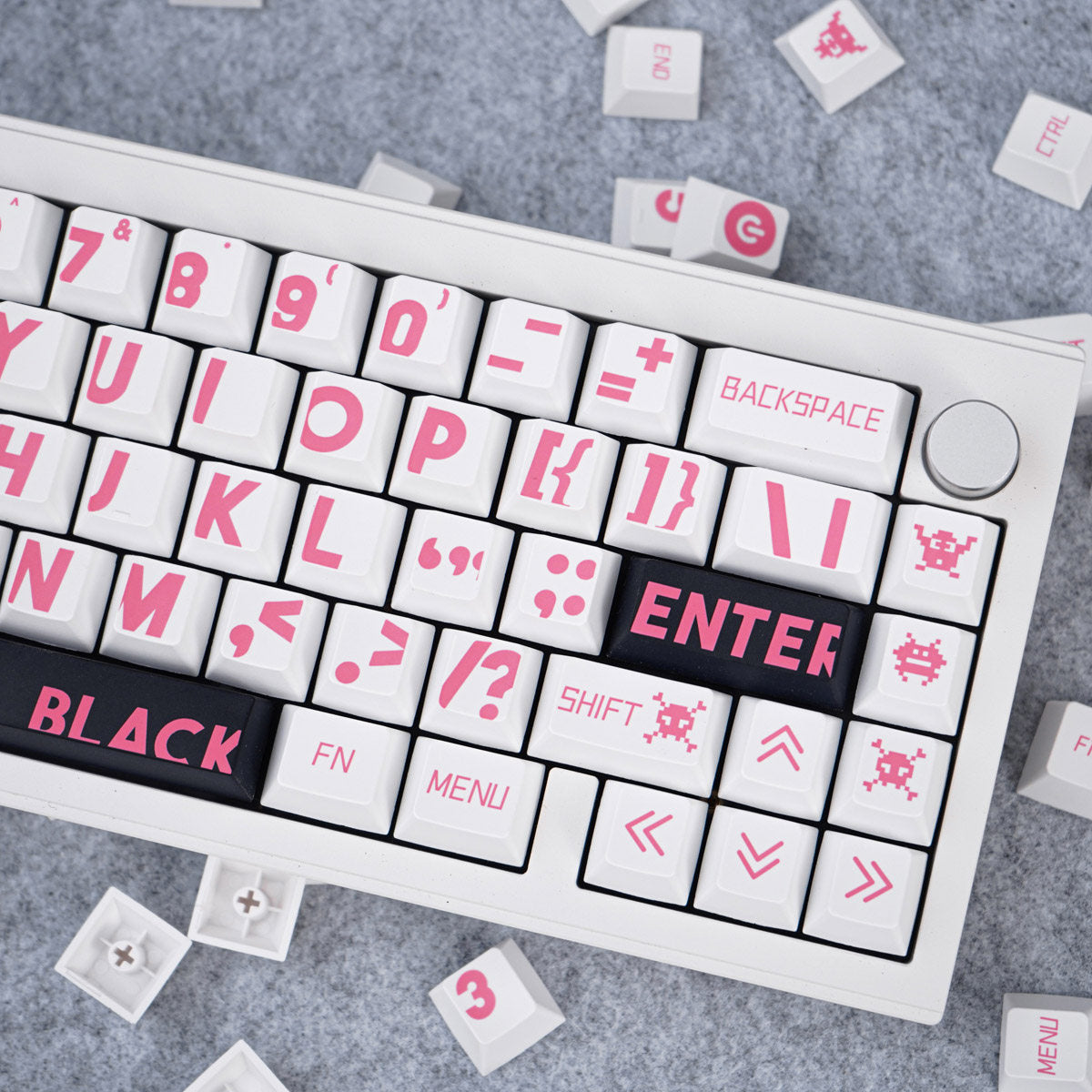 Keyboard with pink lettering on a gray surface